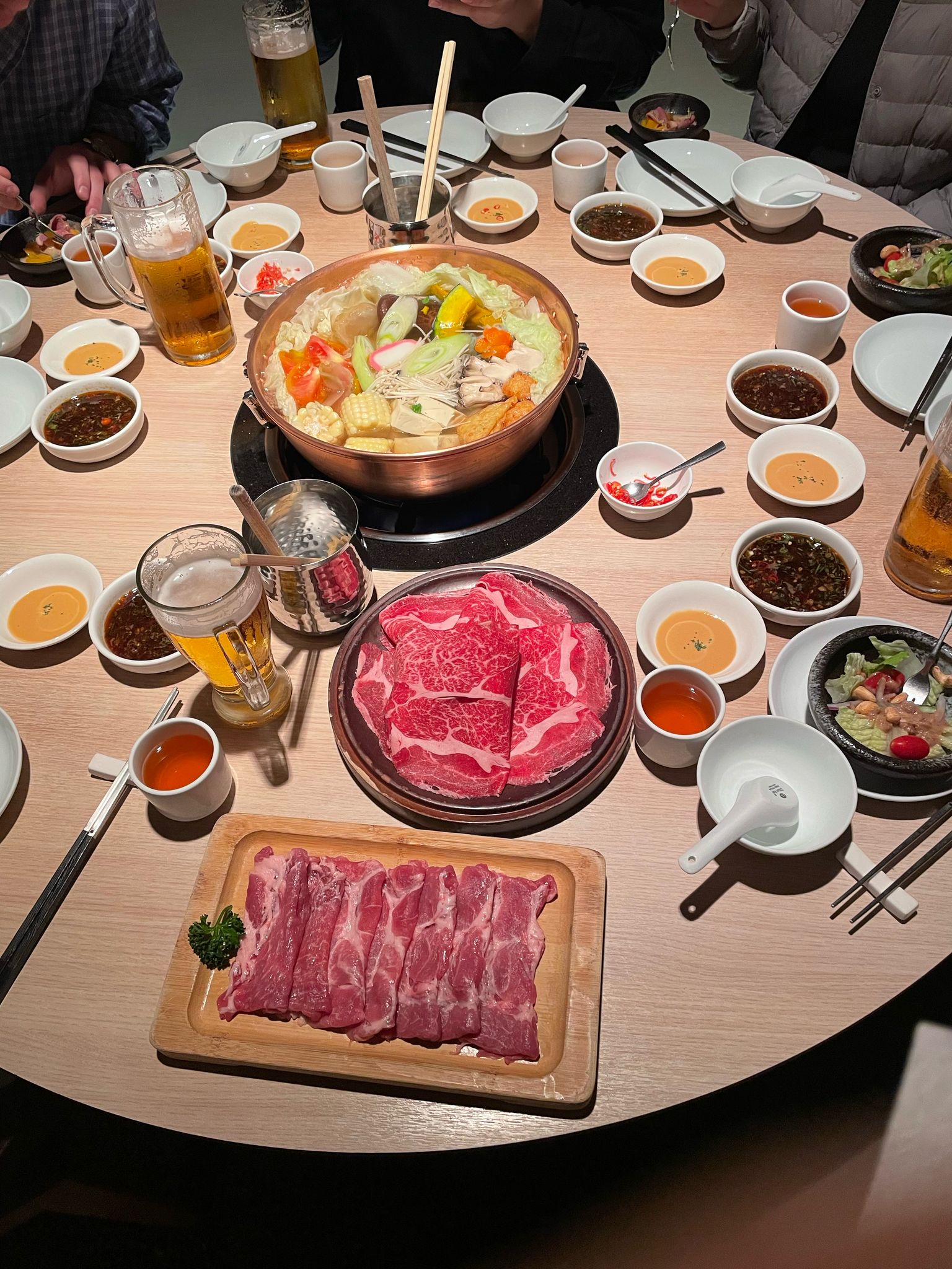 The whole family around a shared hot pot table